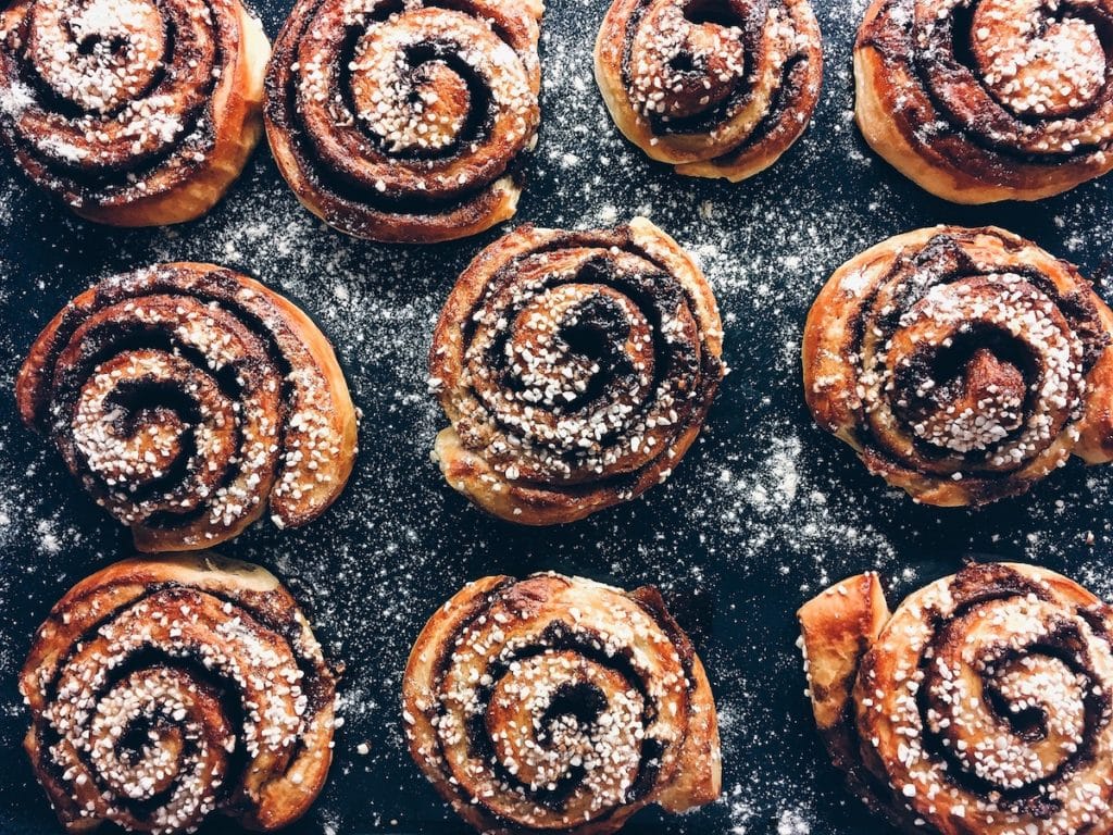 cinnamon buns dusted with icing sugar